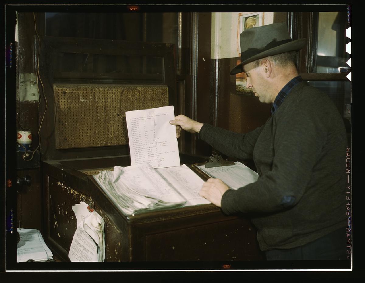 Switch lists coming in by teletype to the hump office at a Chicago and Northwestern railroad yard, Chicago, Illinois. c. 1939