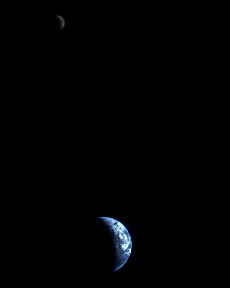 A crescent-shaped Earth and Moon recorded by Voyager 1 in 1977 - the first photo of its kind ever taken by a spacecraft