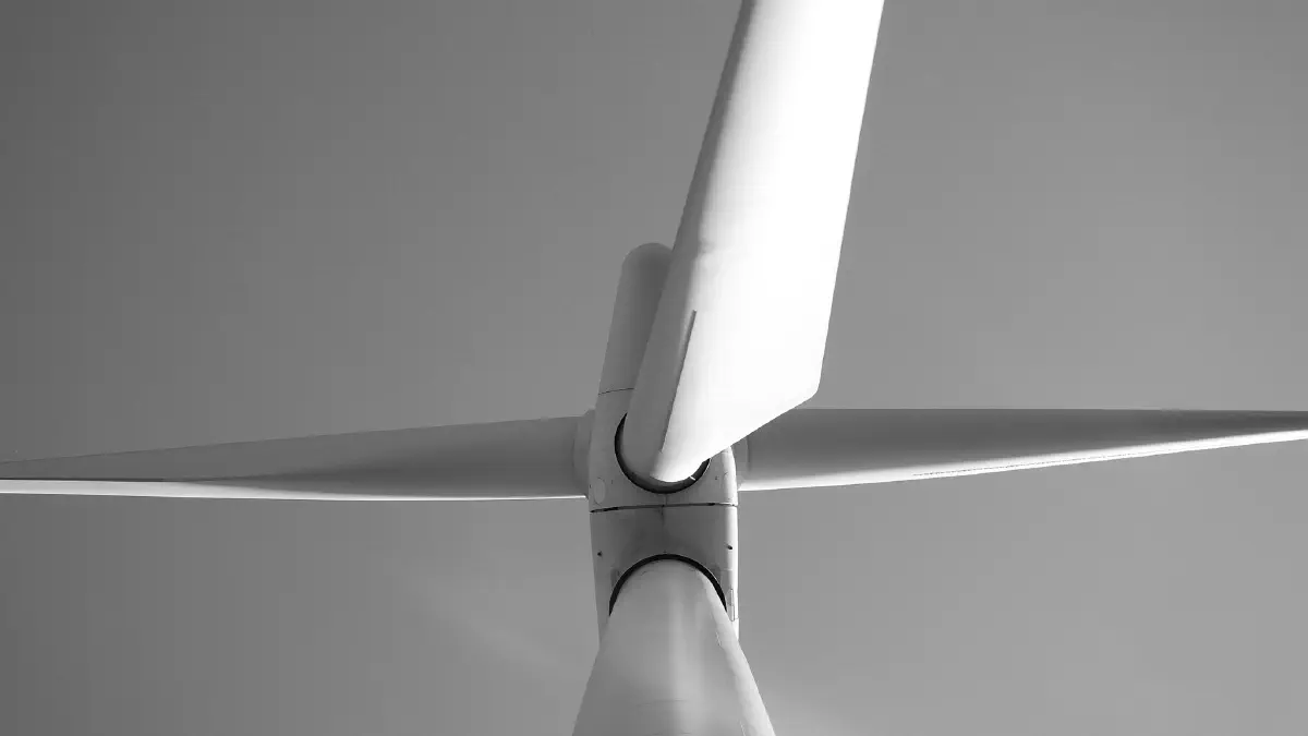 Black and white photos of a wind turbine, viewed from below.