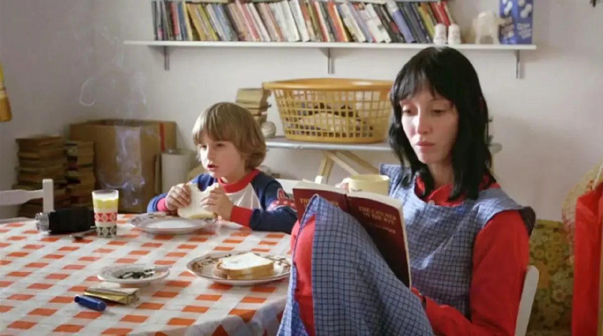 Still from the film The Shining. Wendy, played by Shelley Duvall, sits at the table with Danny